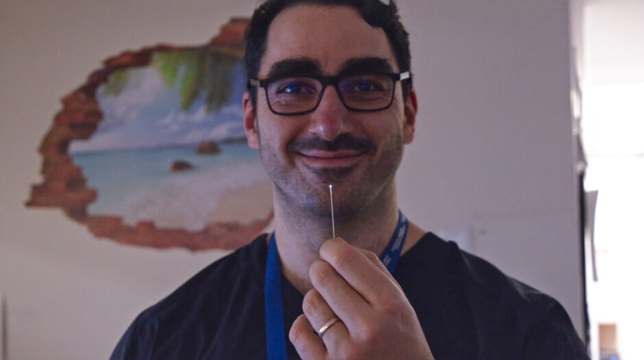 Dr. Fahed holding the microangioscope, which is a tiny camera.