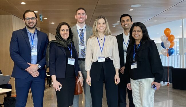 A group photo of Velocity director of health Moazam Khan, Atefeh Zarabadi, founder of AiimSense, Andrew Cordssen-David of HeadFirst, Alison Smith of Roga, Jayiesh Singh of Able Innovations, and Shalini Gupta of Asima Health. They are looking straight into the camera, smiling.