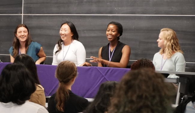 Osose Itua in the centre of a panel with four women speaking and laughing.