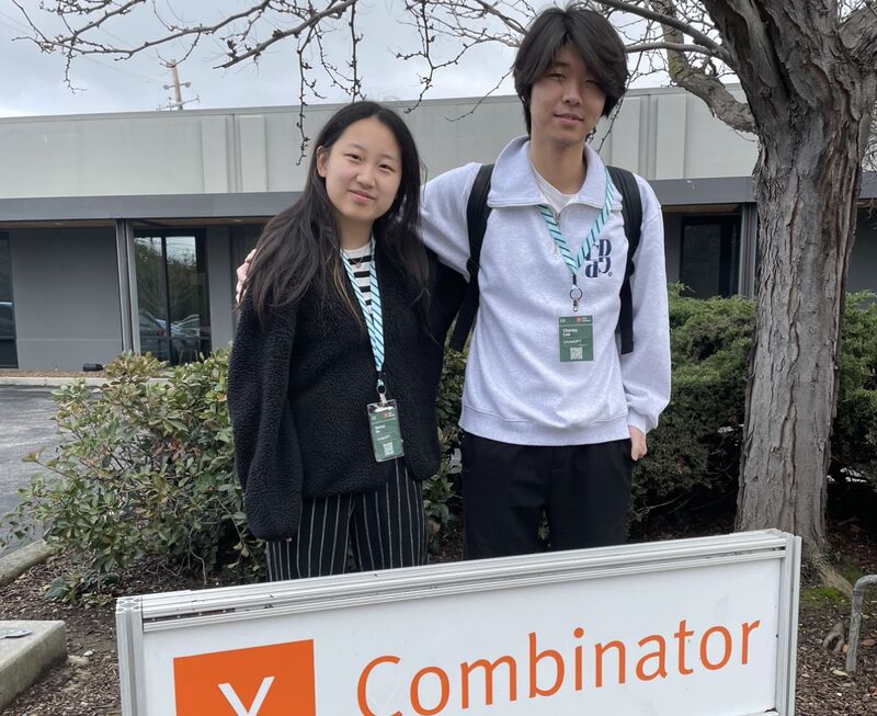 A photo of Datacurve founders standing behind the Y-combinator sign